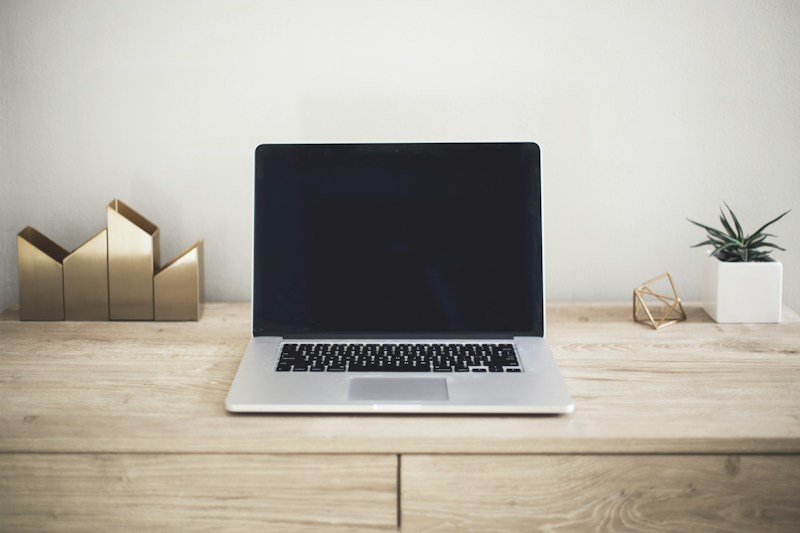 Laptop on a desk in a bright workspace